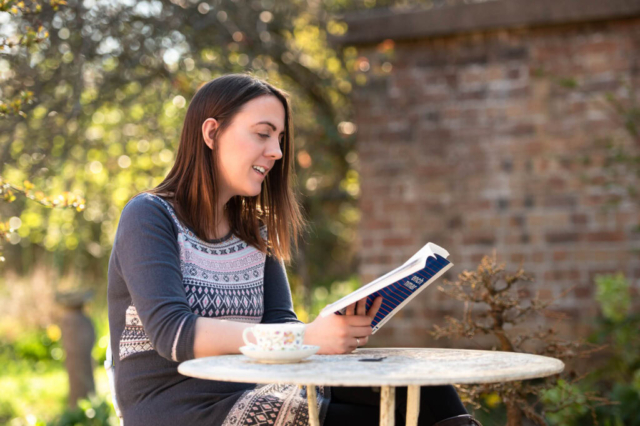 Edinburgh brand photography, Scotland - small business owner sitting at cafe table reading