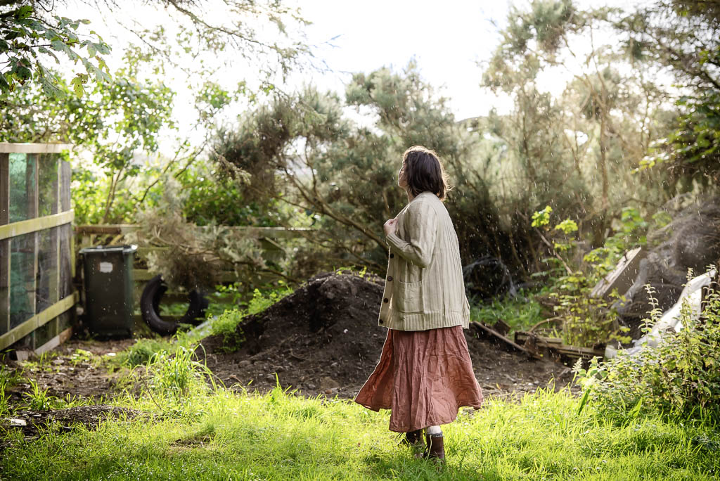 Brand photography shoot for homesteader in Buckie, Morray - woman standing looking away from the camera in the rain