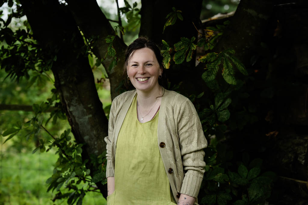 Moray brand photographer Scotland - woman standing against tree smiling